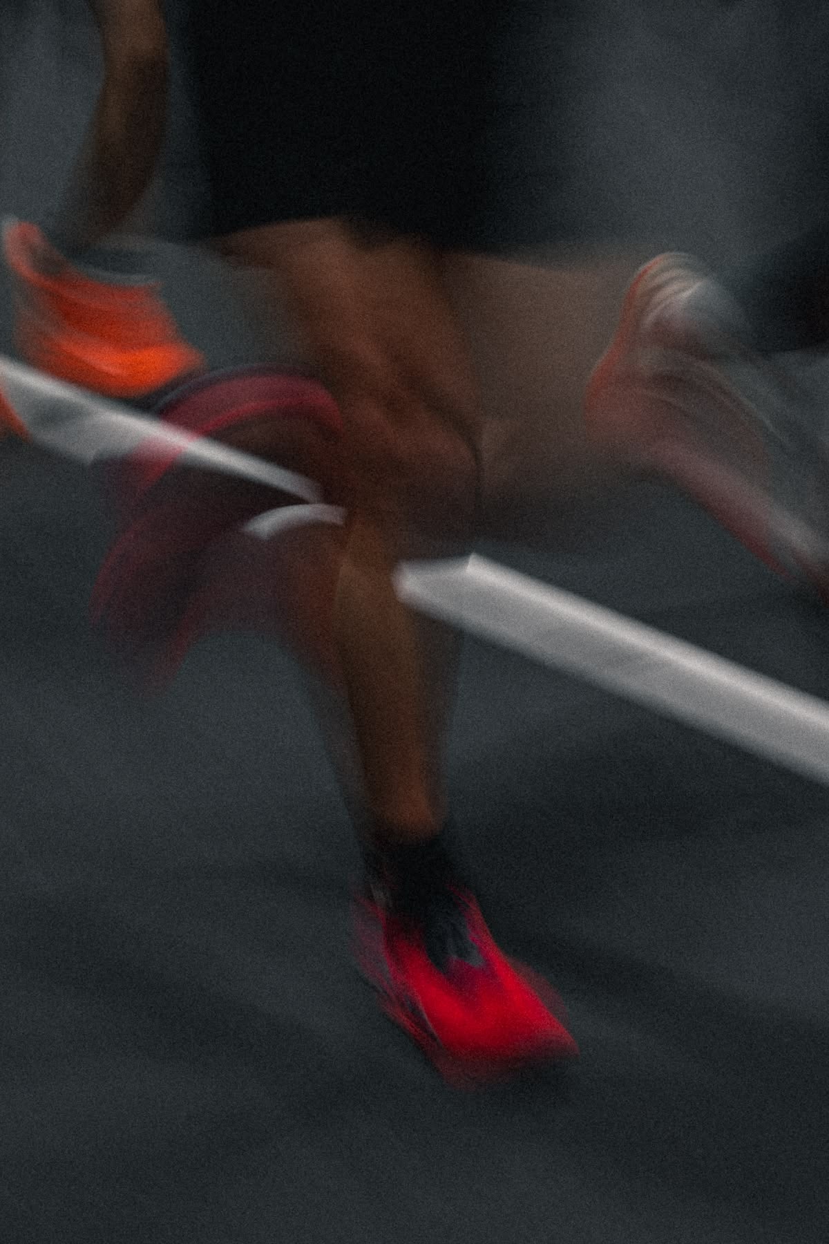 Runner in motion on an outdoor track